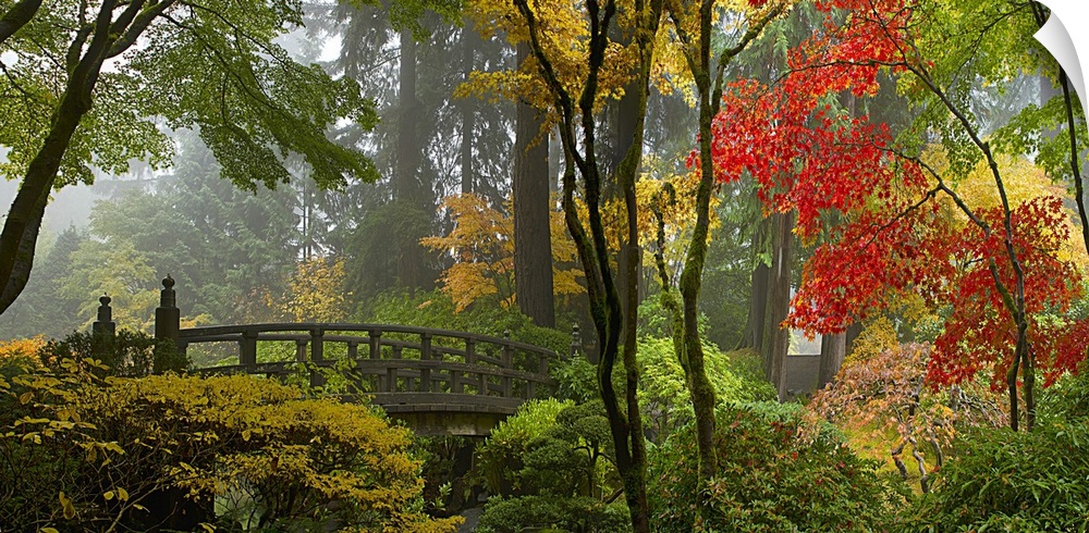 Wooden bridge at Portland Japanese Garden in fall one foggy morning.