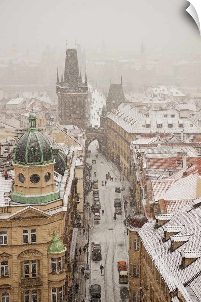 Czech Republic, Central Bohemia Region, Prague, Bohemia, Central Europe, View of the town under the snow from St Nicholaus...