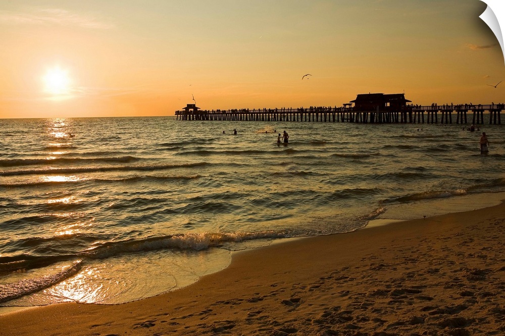 Florida, Naples, beach and Naples Pier at sunset.