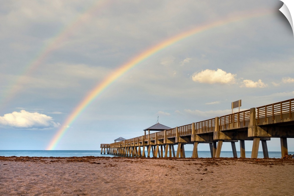Florida, South Florida, rainbow over Juno Beach pier.