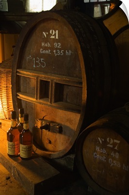 France, Normandy, Barrels and bottlesn of Calvados in a producer's cellar