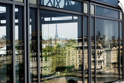 France, Paris, Institut du Monde Arabe with Eiffel Tower reflected on the window