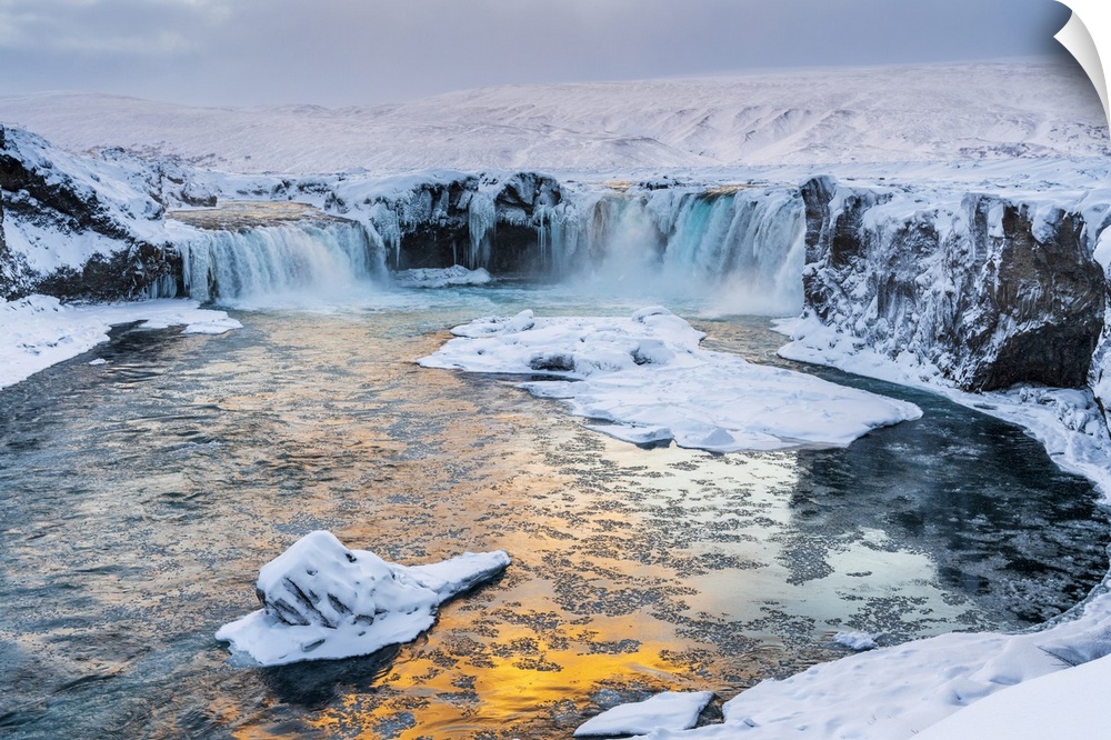 Iceland, Northeast Iceland, Sunset over a snow-covered Godafoss.