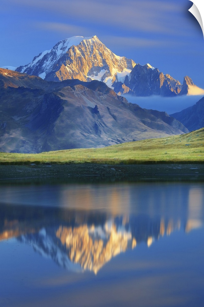 Italy, La Thuile, Little St Bernard Pass, Alps, Mont Blanc Mountain, Mont Blanc is reflected at dawn in a small lake above...