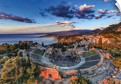 Italy, Sicily, Aerial View Of Taormina, The Greek Theater And Mount Etna In Eruption