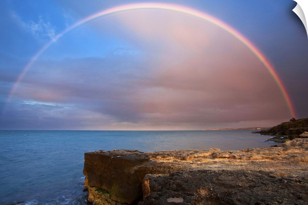 Italy, Sicily, Mediterranean sea, Costa Saracena, Siracusa district, Augusta, Rainbow over the sea at sunset.