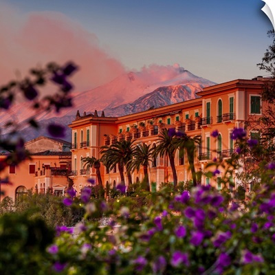 Italy, Taormina, San Domenico Palace Hotel at sunset with Mount Etna in the background