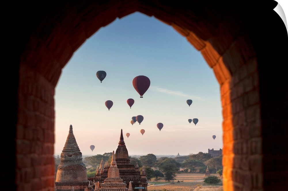 Myanmar, Mandalay, Bagan at dawn, Buddhist Temple, Stupas with desert land sky full of hot-air balloons.