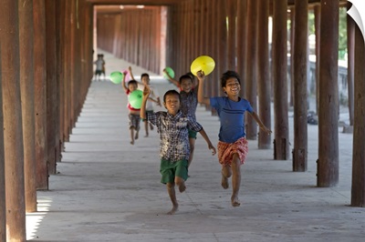 Myanmar, Mandalay, Bagan, Local children running along a passage with balloons