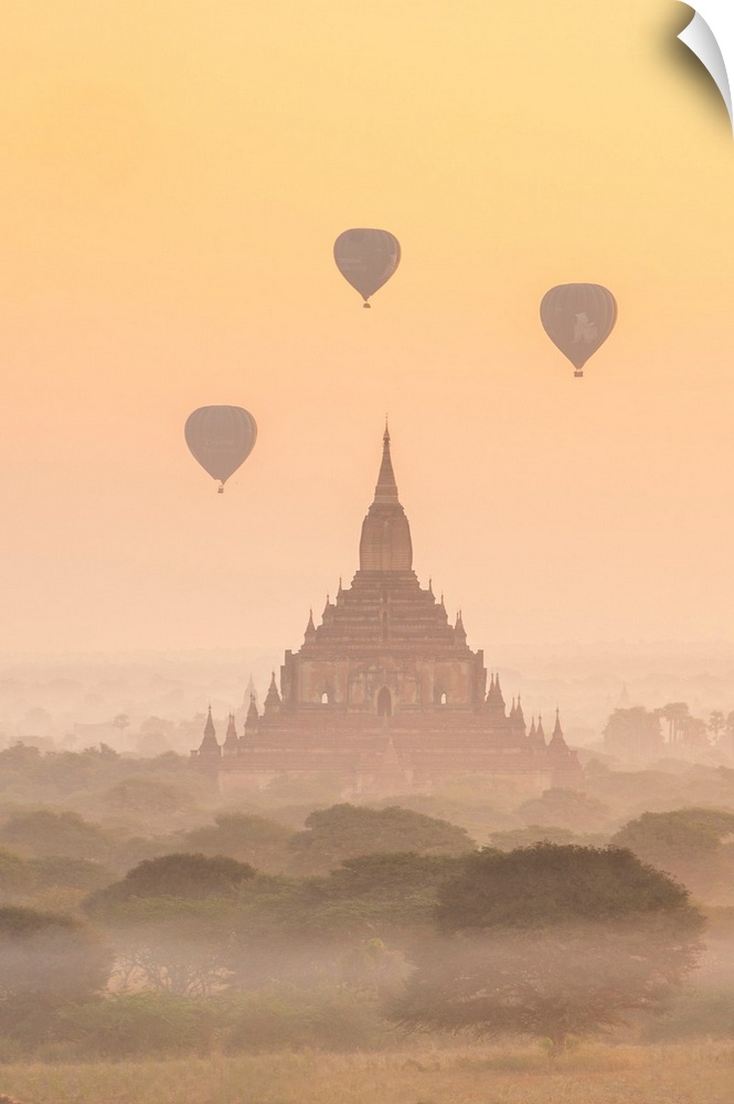 Myanmar, Mandalay, Bagan, Sulamani temple at sunrise with balloons in the sky.