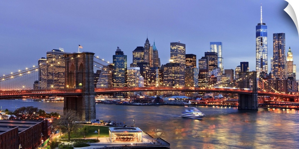 USA, New York City, East River, Manhattan, Brooklyn Bridge, Downtown skyline with the Freedom Tower illuminated at dusk, v...