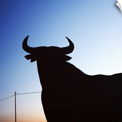 Spain, Costa Blanca, Alicante, Bull billboard sign at sunset