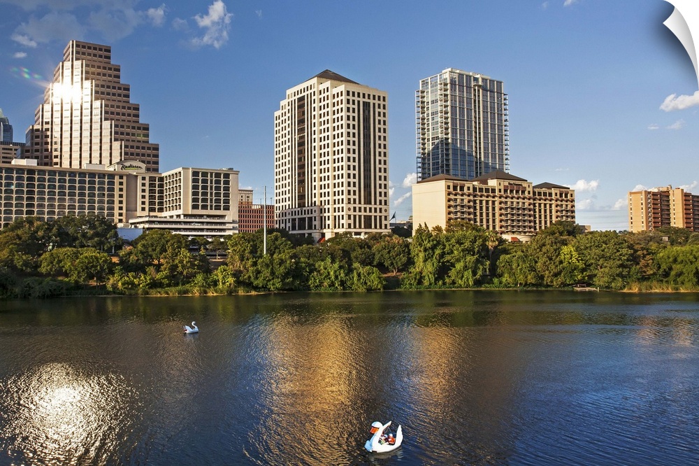 Texas, Austin, view over Colorado River from Congress Ave. Bridge looking toward downtown with swan paddle boats