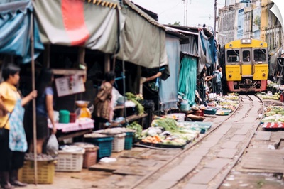 Thailand, Maeklong Railway Market, traders clearing the tracks as the train approaches
