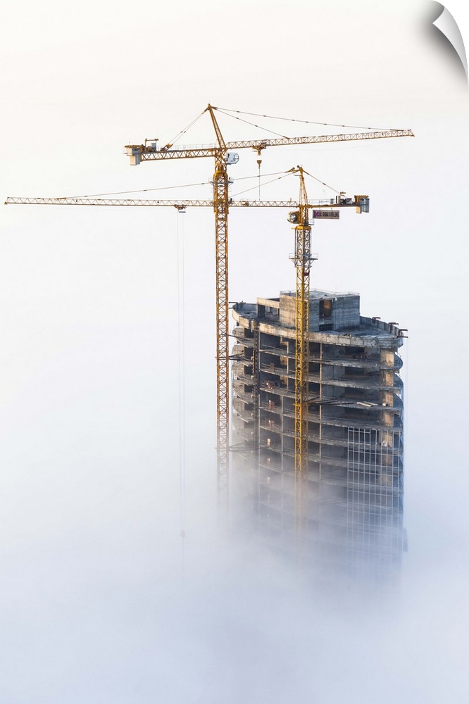 United Arab Emirates, Dubai, Dubai City, Construction in early morning fog.