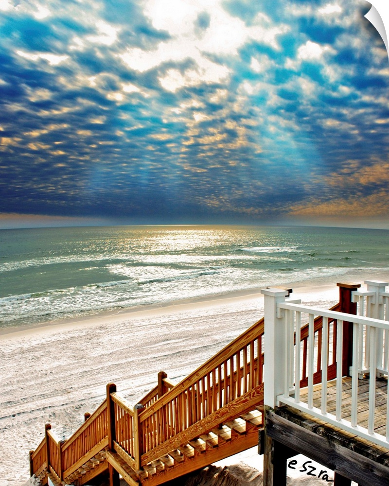 A beach Staircase leading to a glistening sea.