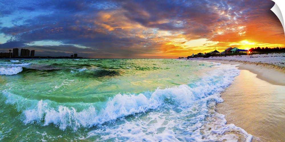 Beautiful ocean sunset with crashing waves and a vibrant red sunset on the beach. Makes a great panoramic canvas print.