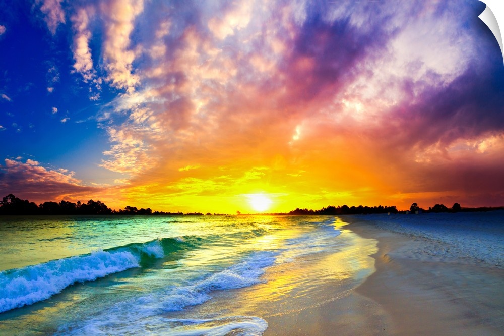 Beautiful emerald ocean waves below a purple sunset.