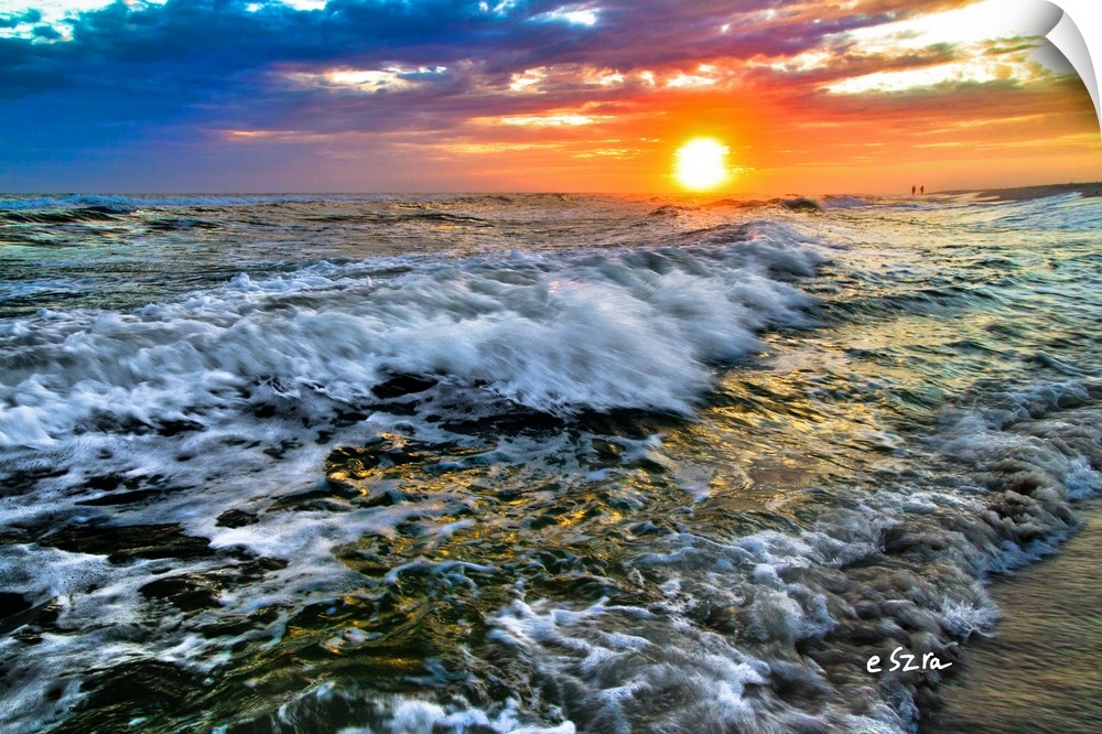 A red purple and blue sunset over breaking waves on a Florida beach.