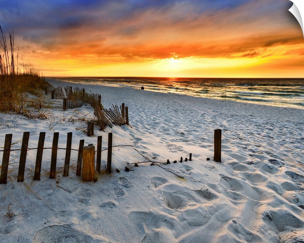 A sandy beach before a bright red sunset on the beach. The sand in This part of Florida is bright white. Landscape taken o...