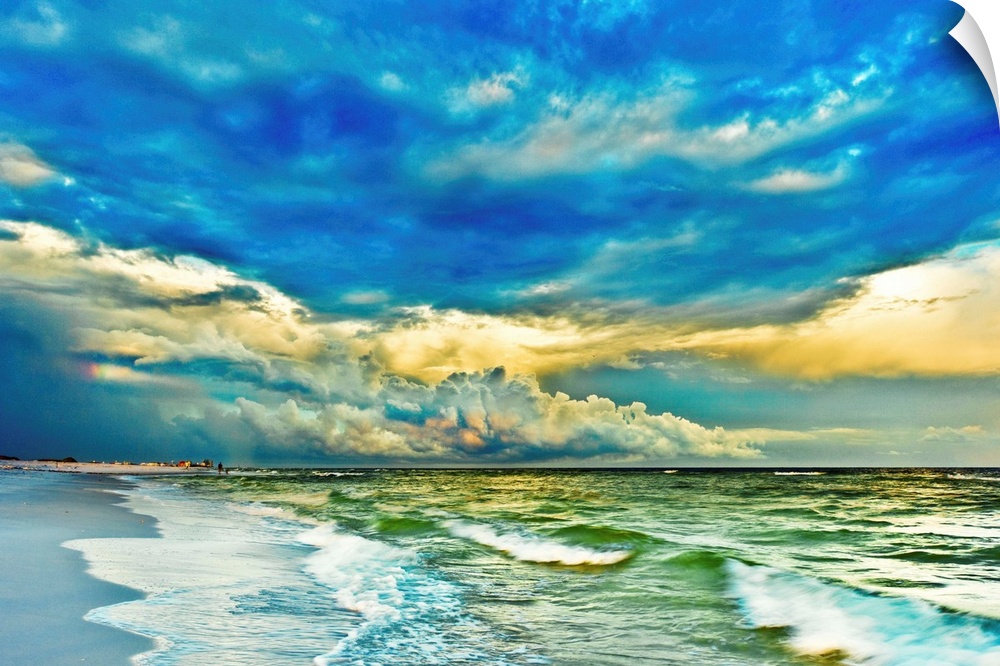 A blue and green painted looking seascape with blue clouds and waves breaking in emerald green waters. Landscape taken nea...