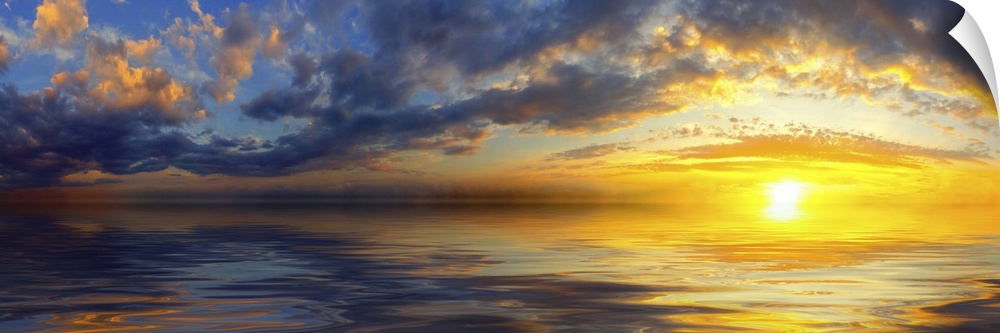 A beautiful panoramic sunset with bright yellow clouds and a golden cloudscape reflected in the sea.