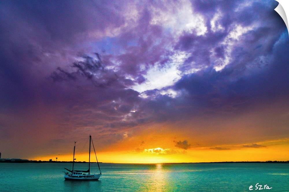 A red and purple over and aqua sea with sail boat.