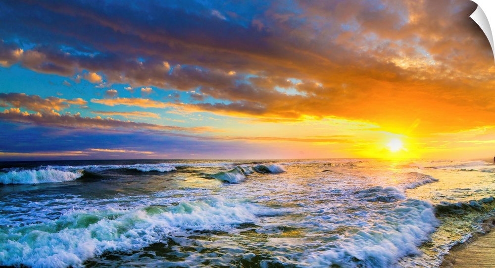 A beautiful red sunset panorama of an ocean sunset. This landscape features a red ocean sunset with waves.
