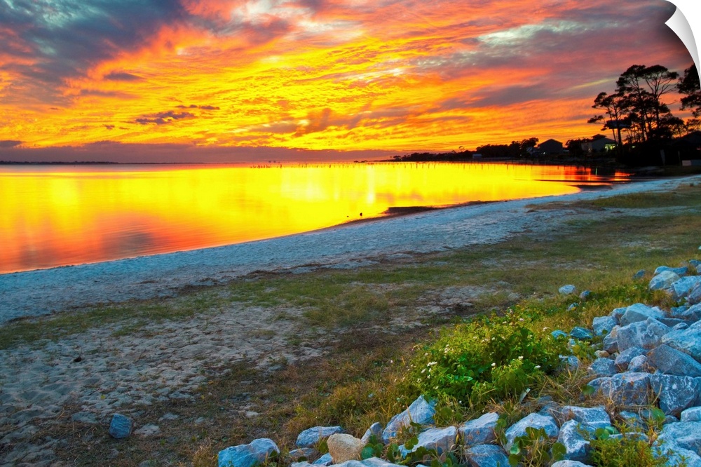 A vibrant orange sunset reflected on the lake.