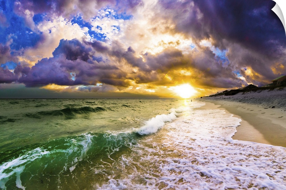 A dark sunset featuring sun through breaking waves of white surf on beach.