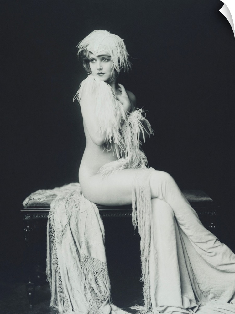 Actress and Ziegfeld girl Claudia Dell. Full length portrait of Dell nude and draped in feathers and cloth. Ziegfeld claim...