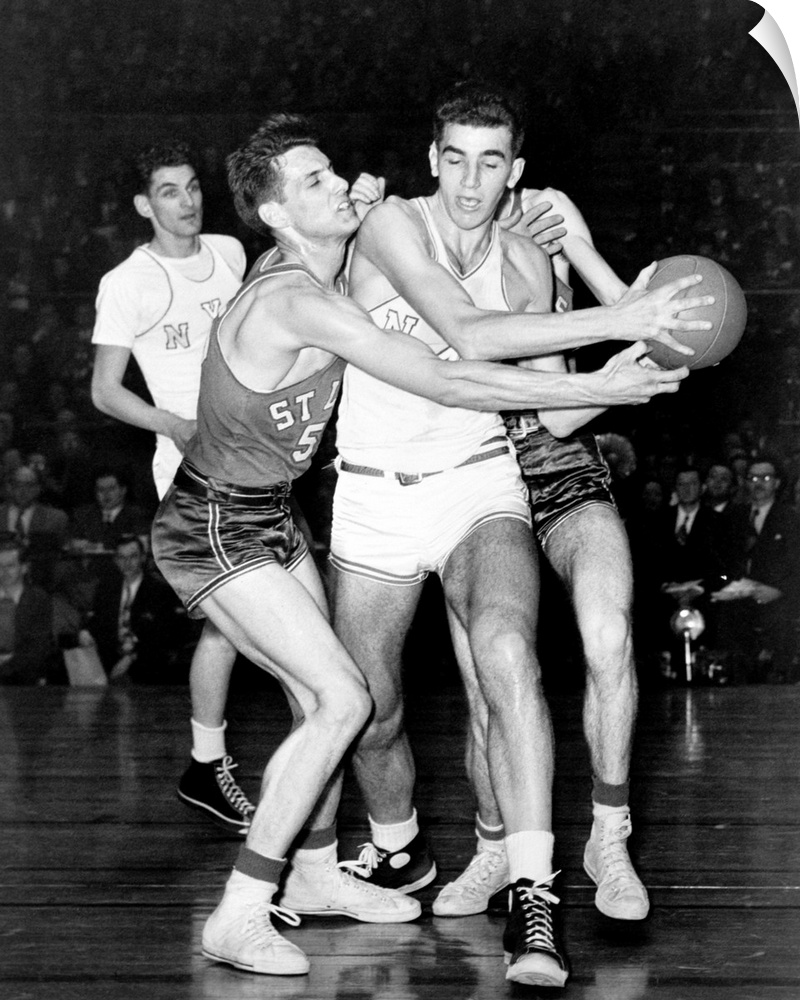 Adolph 'Dolph' Schayes keeping the basketball away from Joe Ossola of St. Louis University, 1948. Schayes, playing for New...