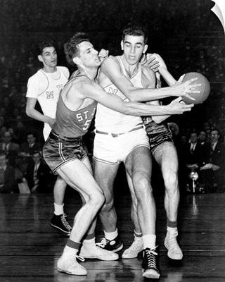 Adolph 'Dolph' Schayes keeping the basketball away from Joe Ossola