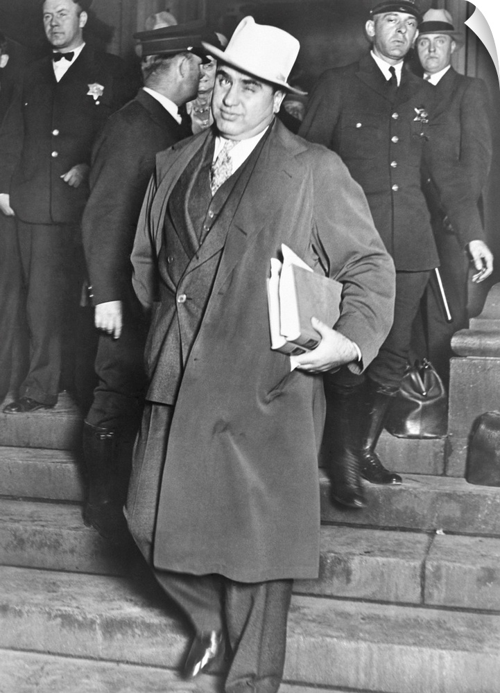 Al Capone, winks at photographers as he leaves Chicago's federal courthouse. October 14, 1931. The notorious Chicago gangs...