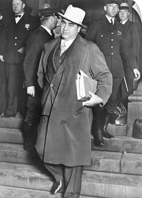 Al Capone, winks at photographers as he leaves Chicago's federal courthouse