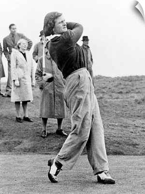 Babe Didrikson, watching golf ball as she completes her swing