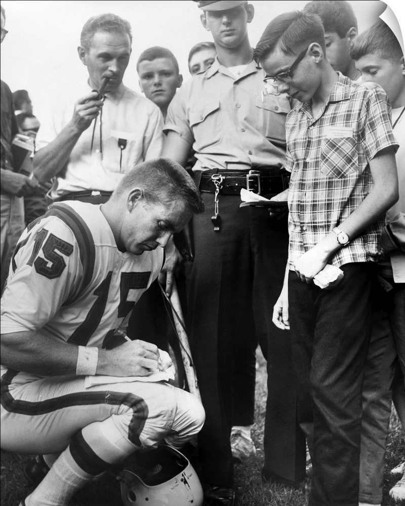 Buffalo Bills player Jack Kemp signs his autograph for a boy on August 4, 1964. Kemp played professional football from 195...