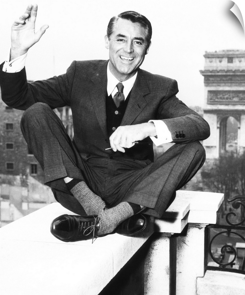 Cary Grant on the balcony of his Paris hotel room overlooking the Arc de Triomphe, 1956.