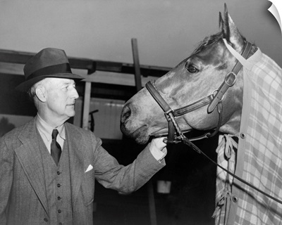 Charles Howard admiring his horse Seabiscuit, March 5, 1940