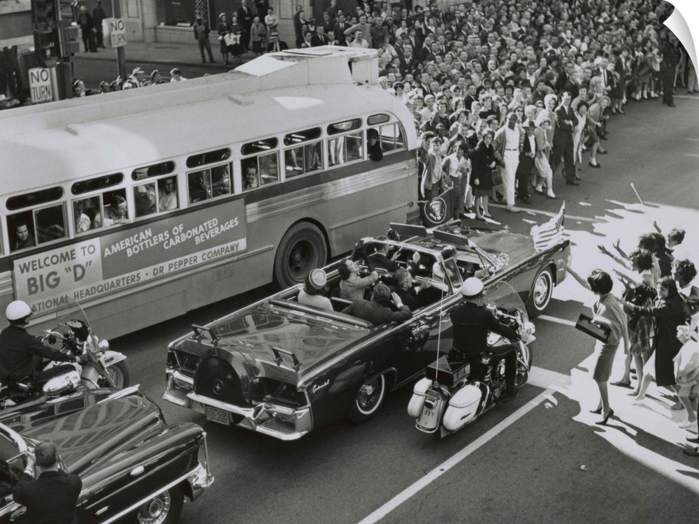 Dallas crowds waving as President Kennedy's limousine drives through downtown Dallas. Texas Governor John Connally and his...