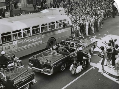 Dallas crowds waving as President Kennedy's limousine drives through downtown Dallas