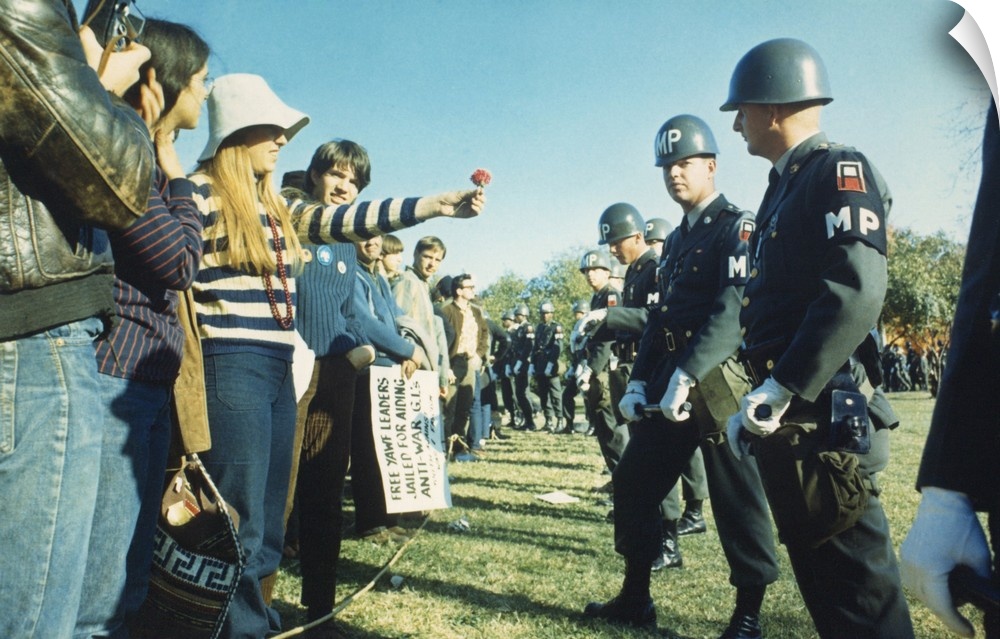 Female demonstrator offers a flower to military police during the 1967 March on the Pentagon. 50,000 Anti-Vietnam War demo...