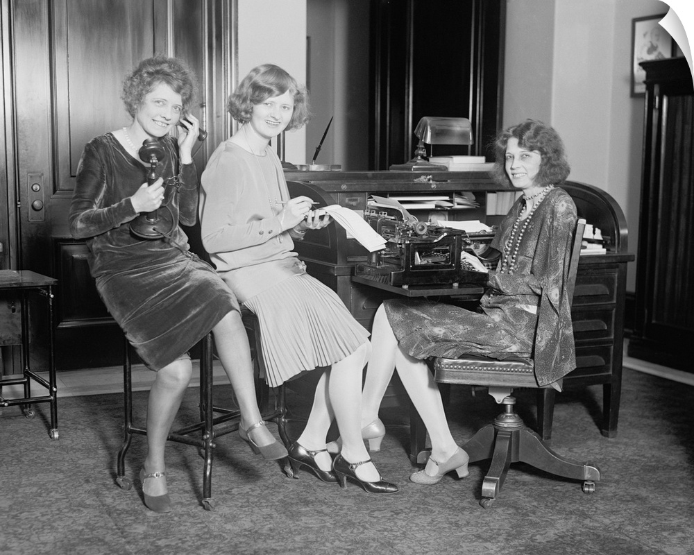 Fashionable young women in a Washington, D.C. office, May 1, 1929. One holds a telephone, another a stenographic pad, and ...