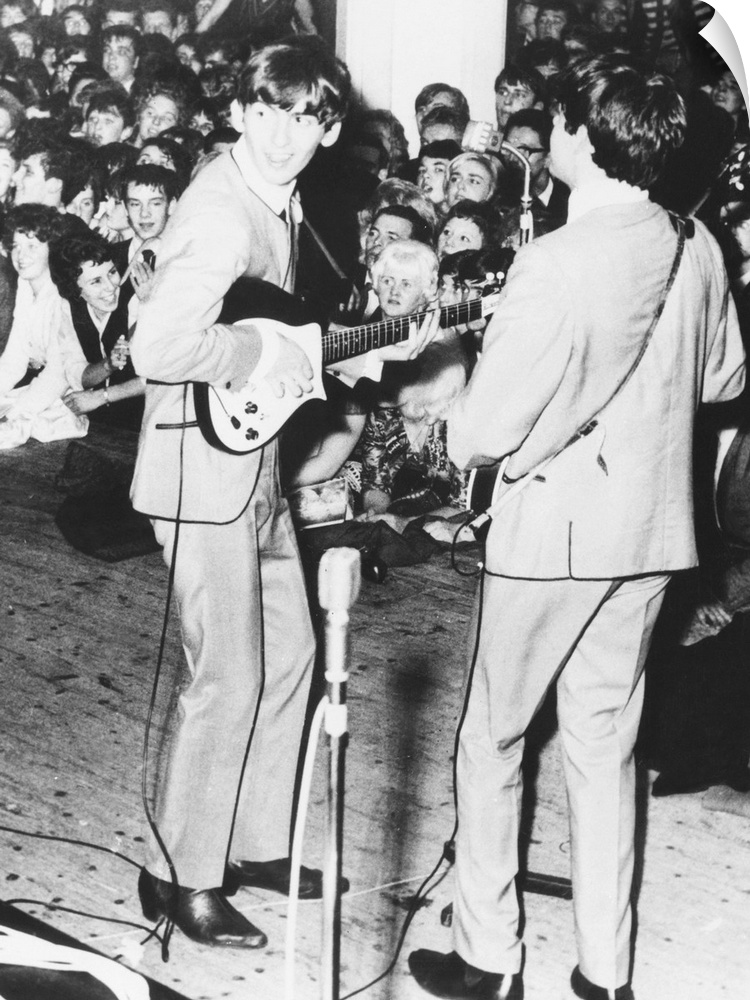 George Harrison and Paul McCartney, of the Beatles perform in Manchester, England. Nov. 11, 1963. The original caption of ...