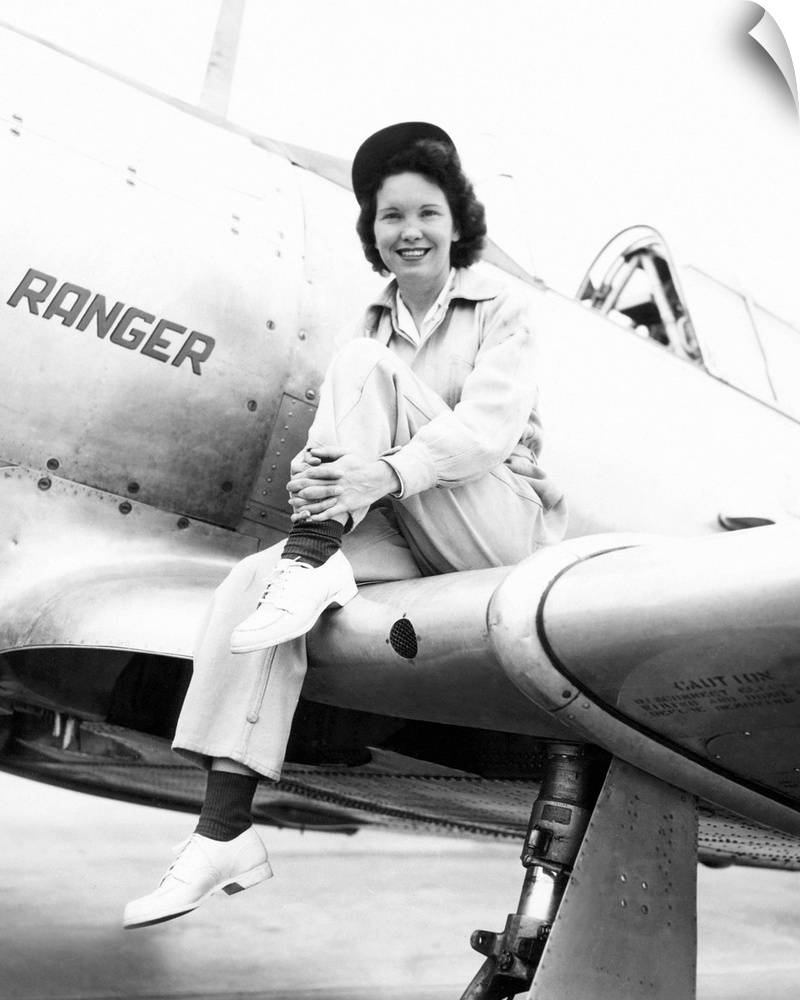 Margaret (Mickey) McGrath, former WASP sitting on the wing of in an XAT-6E trainer aircraft. It was equipped with an exper...