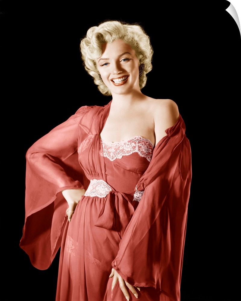 Vintage publicity photograph of Marilyn Monroe, wearing a red robe and dress.