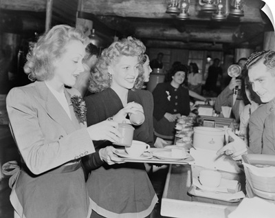 Marlene Dietrich and Rita Hayworth serve soldiers at the Hollywood Canteen