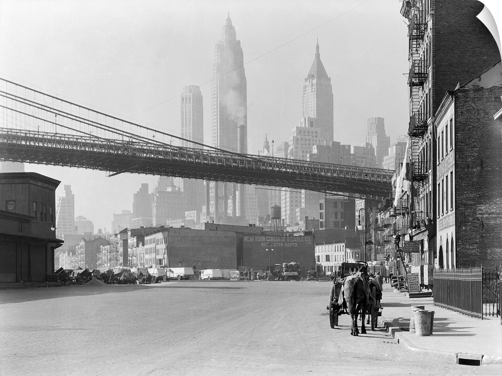 New Your City's South Street, Nov. 28, 1933. The Brooklyn Bridge spans over the street, with the skyscrapers of the Financ...