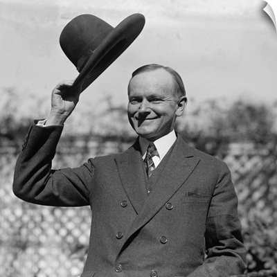 President Calvin Coolidge waves a hat presented to him by Smoki People