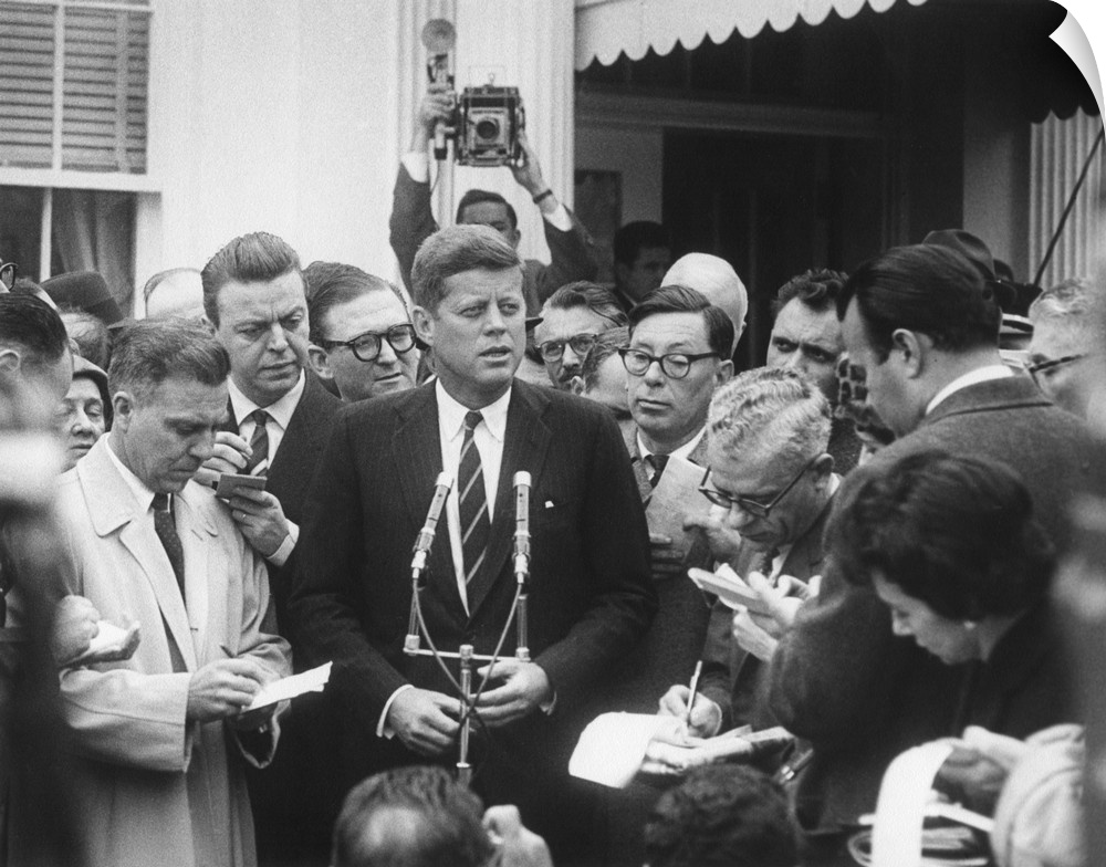President-elect John Kennedy speaks to reporters outside the White House after his meeting with President Dwight Eisenhowe...